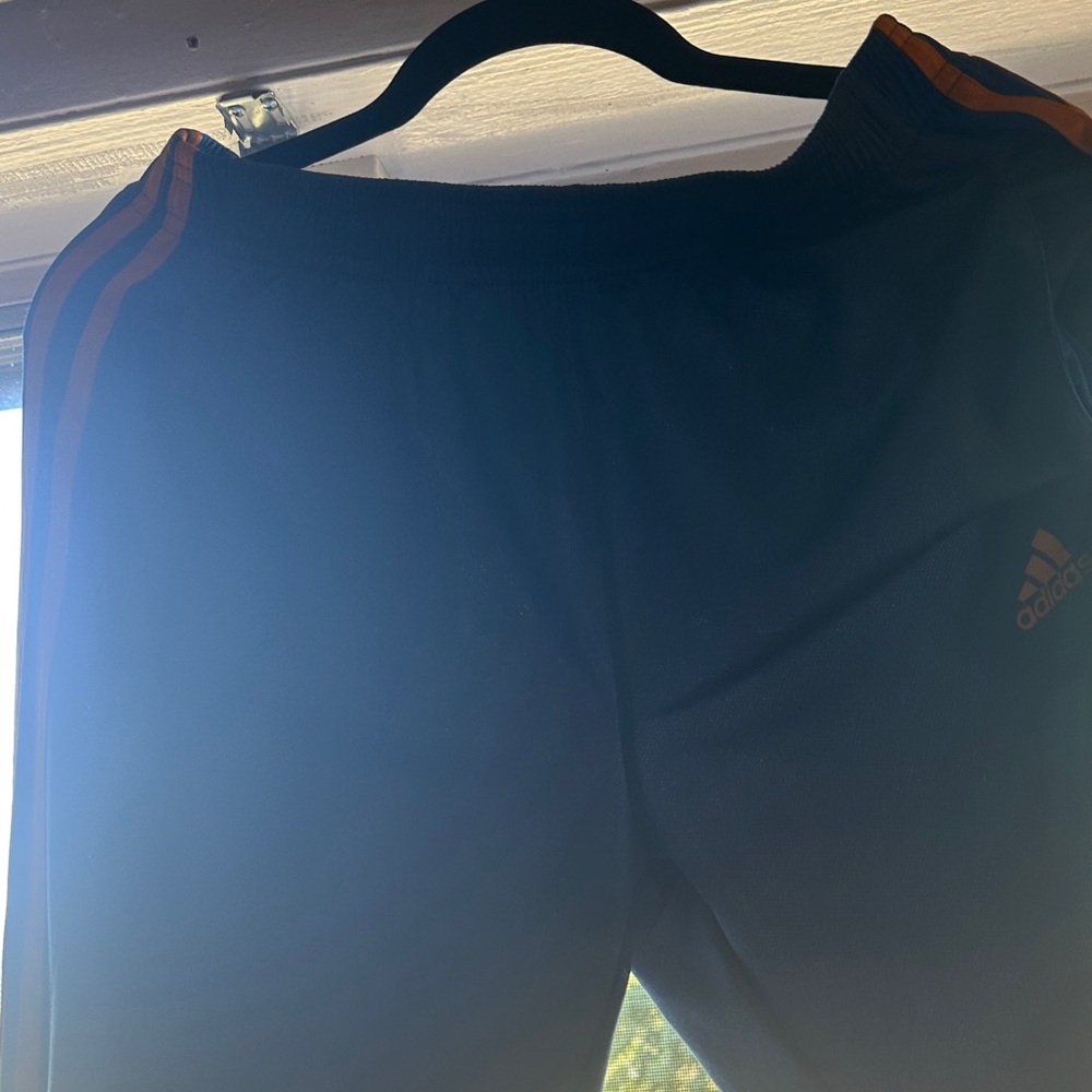 Adidas Black Pants with Vibrant Orange Accents